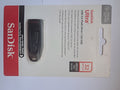 Black SanDisk Ultra 32GB USB 3.0 flash drive in retail packaging